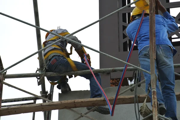 Welders working at high level