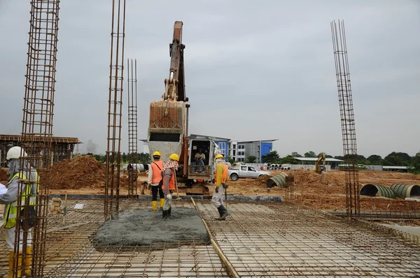 Group of construction workers casting floor slab