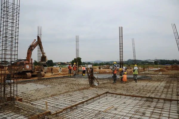 Construction workers fabricating slab reinforcement bar