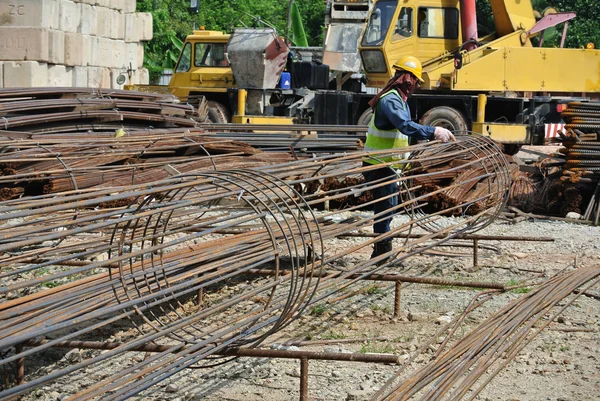 Construction workers fabricated bore pile reinforcement bar at the construction site.