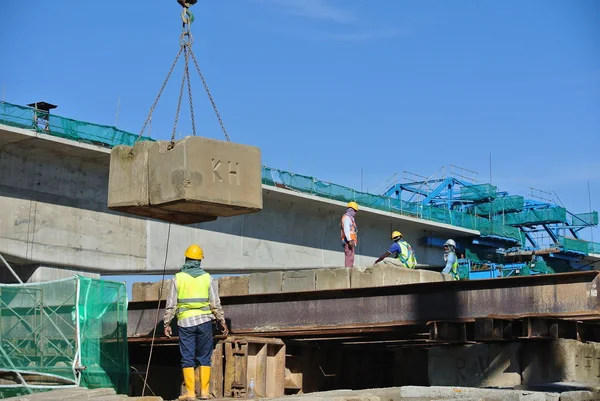 Construction workers stacking the maintain load test block at the construction site