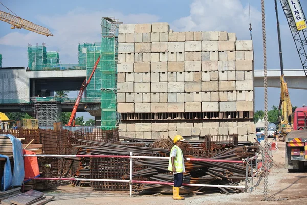 Construction workers stacking the maintain load test block at the construction site