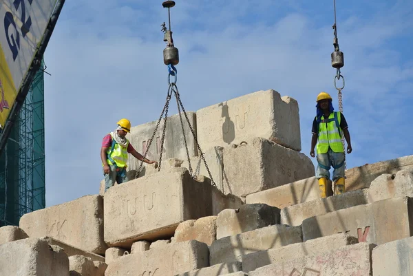 Construction workers stacking the maintain load test block at the construction site