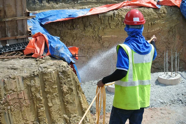 Construction workers spraying the anti termite chemical treatment