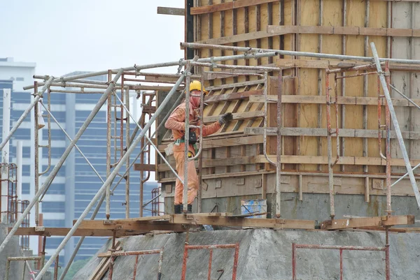 A construction worker fabricating column formwork