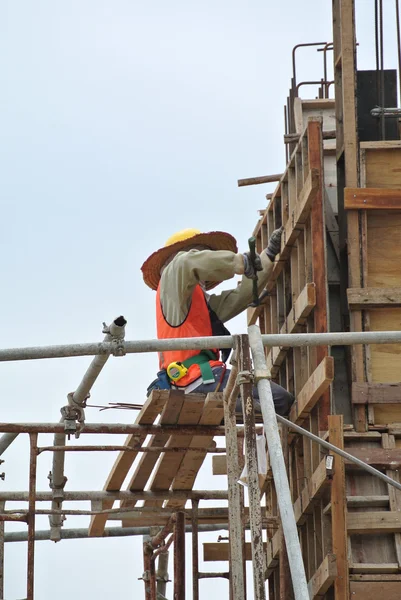 A construction worker fabricating column formwork