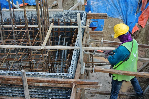 Construction workers installing pile cap formwork