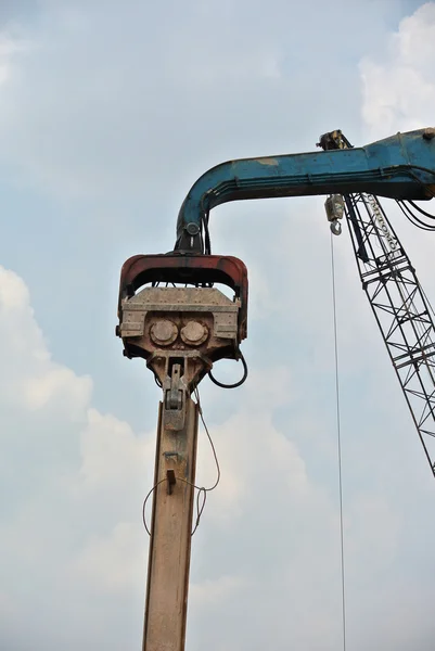 Retaining wall steel sheet pile installation by machine