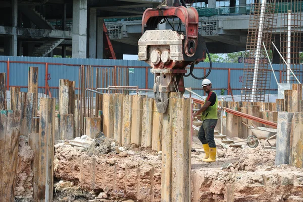 Retaining wall steel sheet pile installation by machine