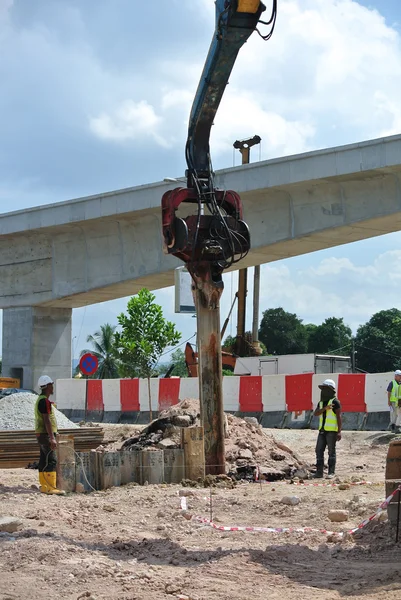 Retaining wall steel sheet pile installation by machine