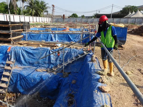 Construction workers spraying the anti termite chemical treatment