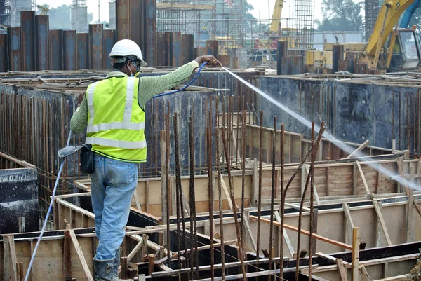 Construction workers spraying the anti termite chemical treatment