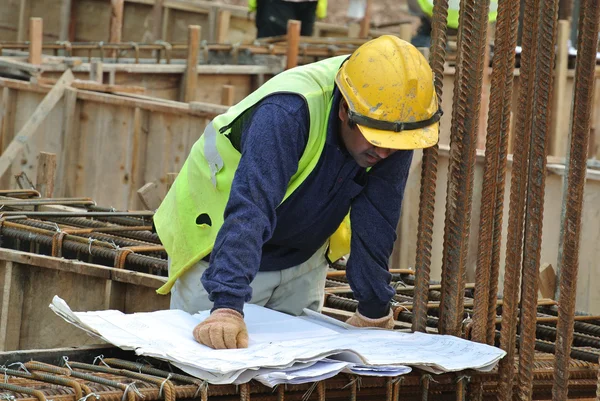 Construction worker referring to the construction drawing