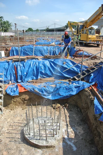 Construction workers spraying the anti termite chemical treatment