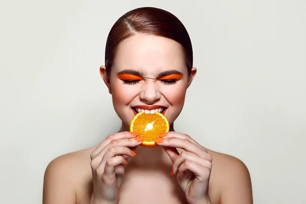 Sour orange. The girl is tasting the fruit.