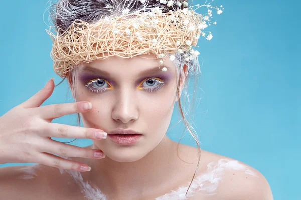 Winter beauty young woman portrait,model creative image with frozen makeup, with porcelain skin and long white lashes showing trendy, Ice-queen, Snow Queen, Easter