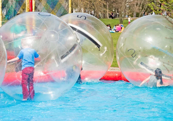 Children playing in water ball