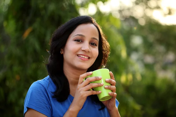 Young woman drinking coffee at outdoors