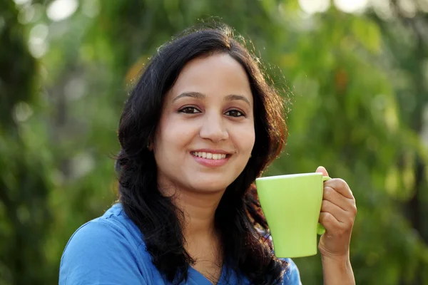 Young woman drinking coffee at outdoors