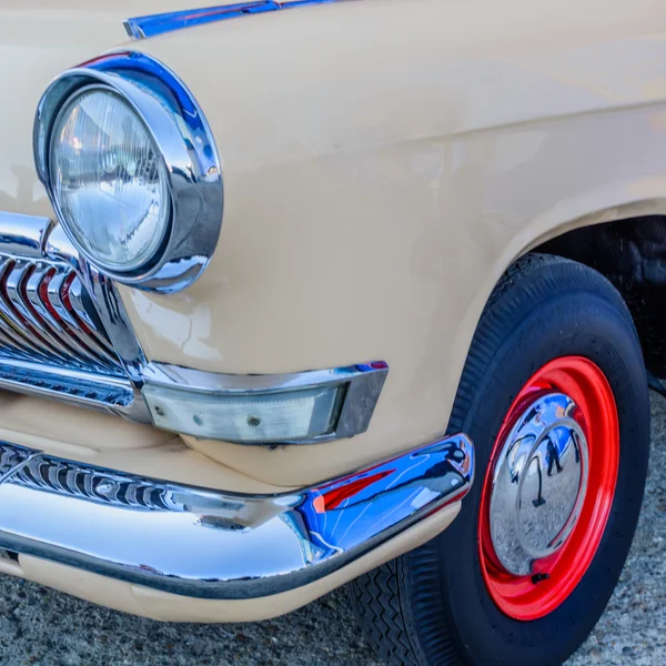 Old vintage car in a square. Horizontal view of a vintage car, s