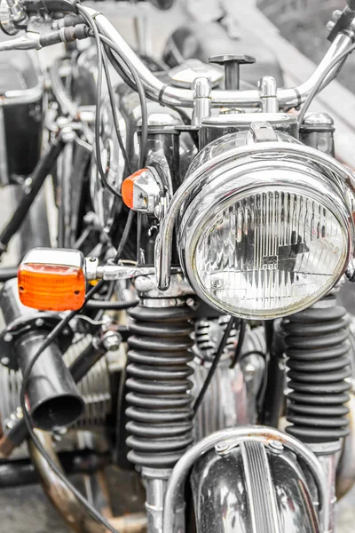Detail on the headlight of a classic motorcycle. Big bike with h