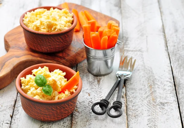 Cheese dip with egg and carrot sticks
