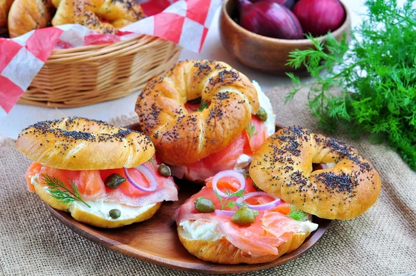Homemade bagel with smoked salmon, cream cheese, capers and onions