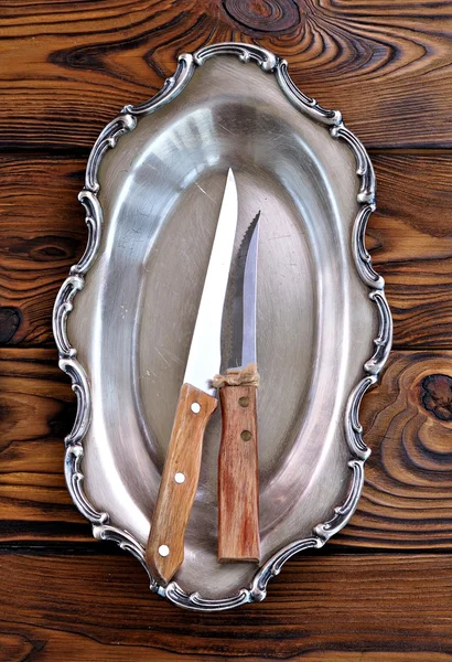 Antique silver cutlery on a wooden table.old knives with wooden handle.