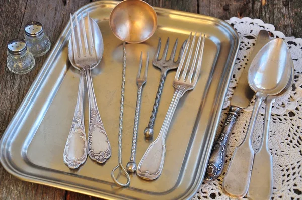 Antiques - cutlery, spoons, forks, knives on a tray,