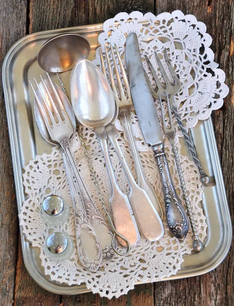 Antiques - cutlery, spoons, forks, knives on a tray,