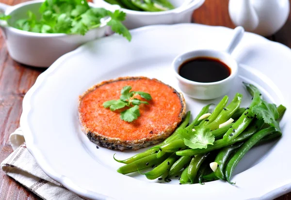 Salmon steak with green beans, garlic, black sesame and soy sauce. Selective focus.