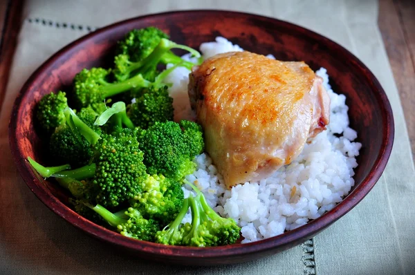 Roasted chicken with rice and broccoli, rustic style