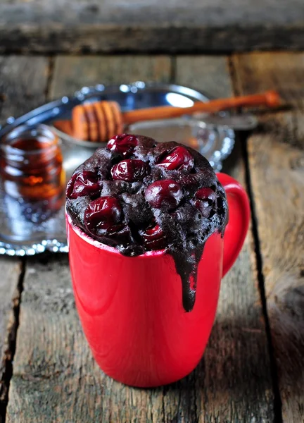 Delicious Mug Cake, chocolate cherry cake cooked in a cup in the microwave