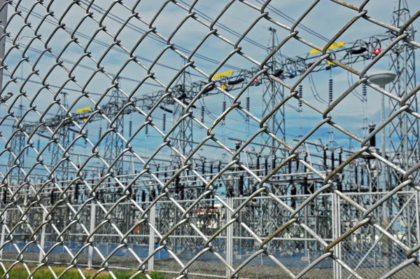Electrical substation behind barbed wire chain link fence