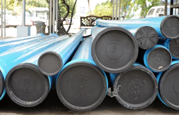 Blue PVC water pipes with covers in the stack