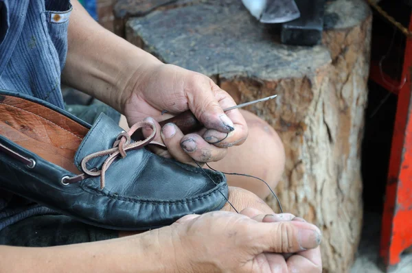Man is repairing shoe