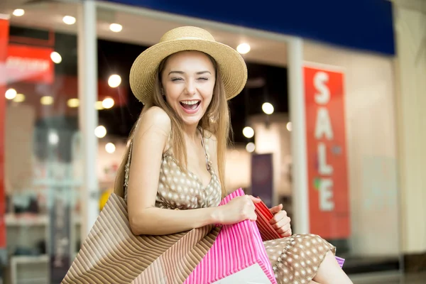 Happy shopping woman laughing squinted