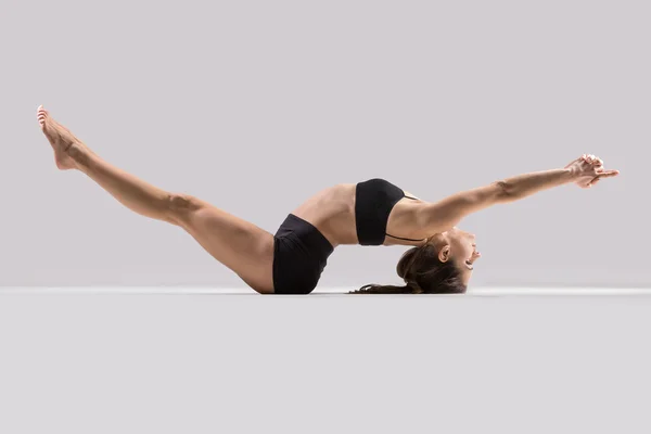 Yogi gymnast girl performs stretching exercise