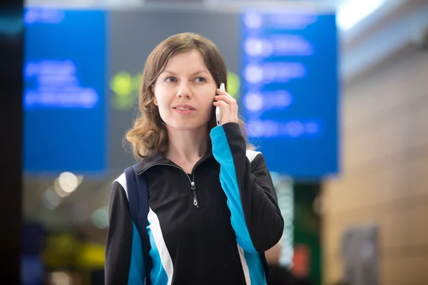Girl on mobile phone in airport