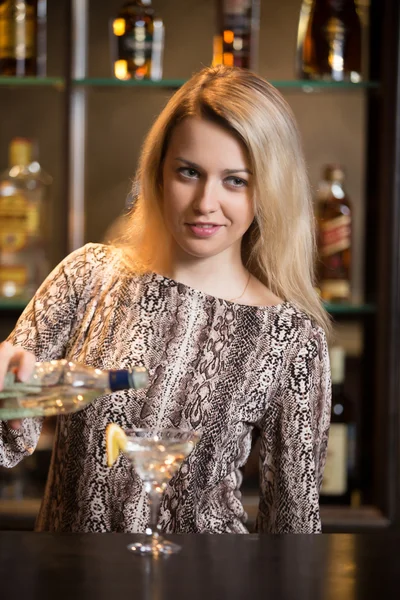Blond bartender making cocktail