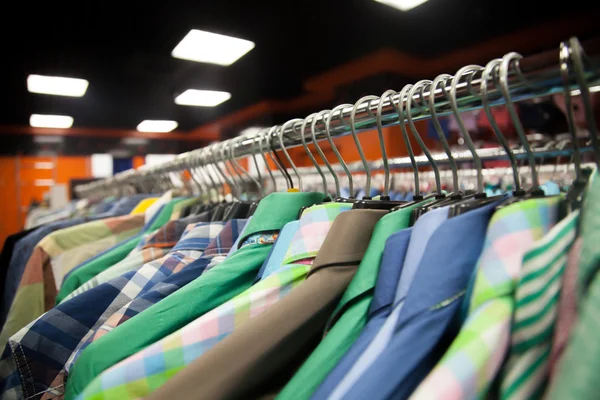 Colorful male shirts in shop