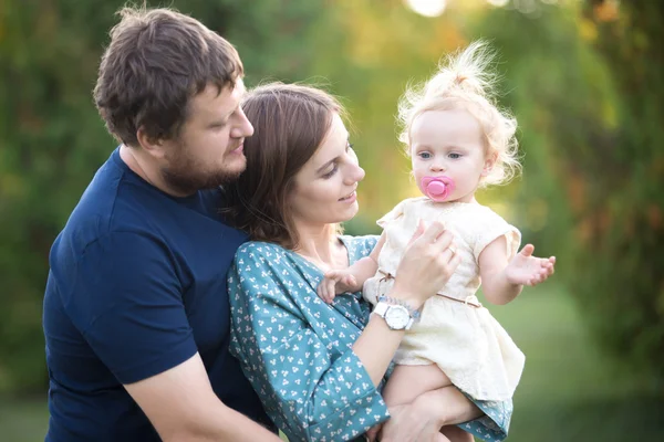 Parents with toddler daughter in park