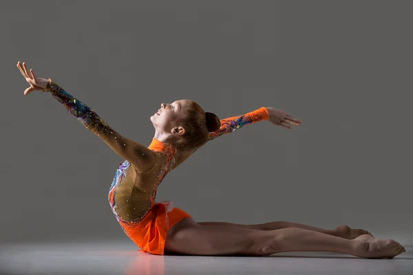 Dancer girl doing backbend gymnastics exercise