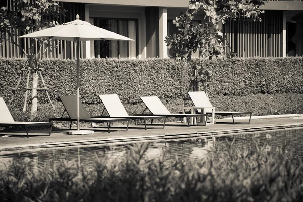 Cream tone photo effected of  Beach chairs  near swimming pool