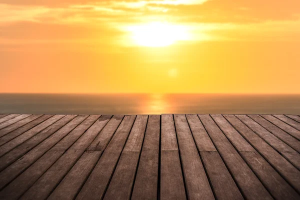 Perspective empty wooden terrace with sunset on sea background