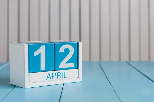 April 12th. Image of april 12 wooden color calendar on white background.  Spring day, empty space for text. Day Of Aviation and Cosmonautics. International DAY OF Human Space Flight