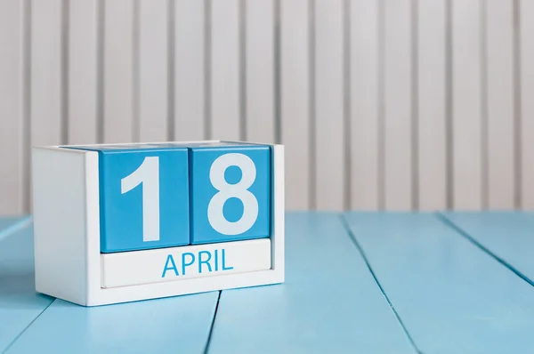 April 18th. Image of april 18 wooden color calendar on white background.  Spring day, empty space for text. International Day For Monuments and Amateur Radio