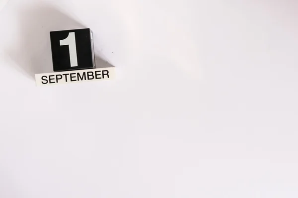 September 1st. Image of september 1 wooden black calendar on white background. Autumn day. Empty space for text. Back to school time