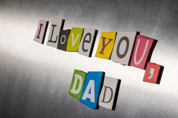 Text love you Dad for fathers day  with color magazine letter clippings on short vintage metal surface. Selective focus