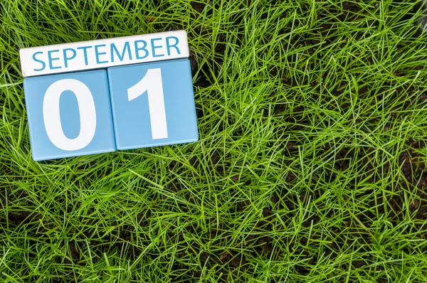 September 1st. Image of september 1 color calendar on green lrass lawn background. Autumn day. Empty space for text. Back to school time